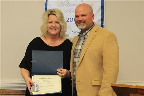 Lisa Thompson with Board President Tobi Burt to receive March Employee of the Month certificate and gift card 